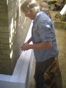 Mike using expanding foam to fill the gaps